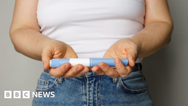 Woman holding a weight-loss jab