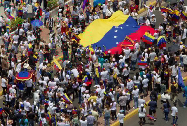 People carry Venezuela's national flag in Maracaibo on July 30 to protest the official election results that awarded President Nicolas Maduro a third term.