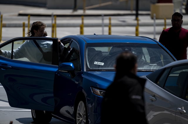 Uber signage on a vehicle at San Francisco International Airport (SFO) in San Francisco, California, US, on Tuesday, July 23, 2024. Uber Technologies Inc. is scheduled to release earnings figures on August 6. Photographer: David Paul Morris/Bloomberg via Getty Images