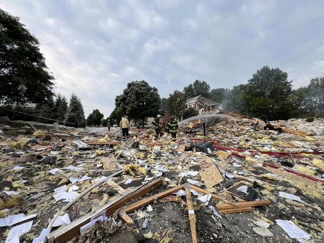 First responders walk through debris in the aftermath of a home explosion in Harford County, Maryland, on August 11, 2024.