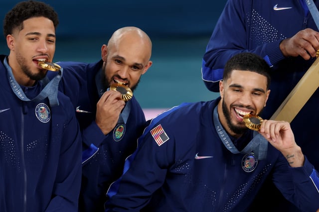 PARIS, FRANCE - AUGUST 10: Gold medalists Tyrese Haliburton, Derrick White, and Jayson Tatum of Team United States pose with their medals on the podium during the Men's basketball medal ceremony on day fifteen of the Olympic Games Paris 2024 at Bercy Arena on August 10, 2024 in Paris, France. (Photo by Jamie Squire/Getty Images)