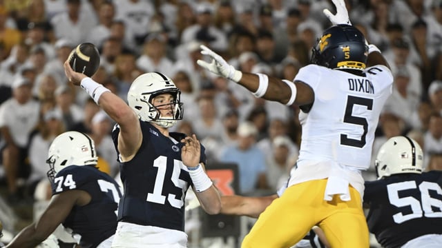 Penn State quarterback Drew Allar (15) passes while pressured by West Virginia linebacker Lance Dixon (5) during the second half of an NCAA college football game, Saturday, Sept. 2, 2023, in State College, Pa. (AP Photo/Barry Reeger)