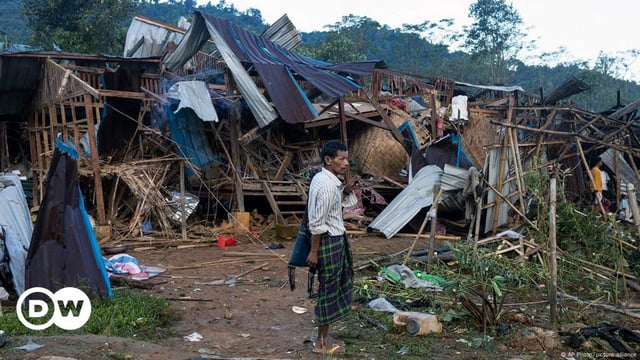 A man looks on at homes destroyed after air and artillery strikes in Mung Lai Hkyet displacement camp, in Laiza, Myanmar on October 10, 2023