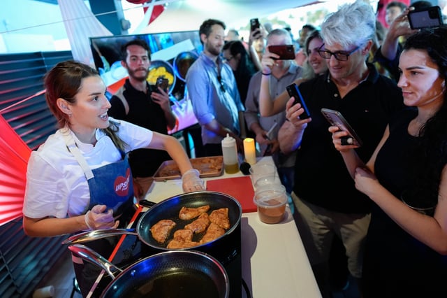 Chef Mika Leon cooks cultivated chicken at a pop-up tasting for "lab-grown" meat produced by California-based Upside Foods, June 27, 2024, in Miami.