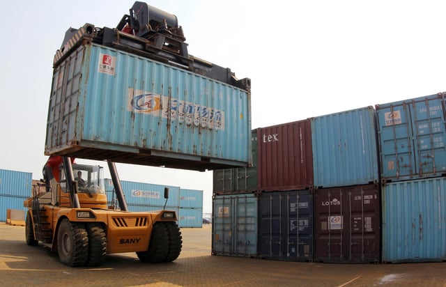 A forklift transfers a shipping container for export at a port in China's Jiangsu province in 2014.