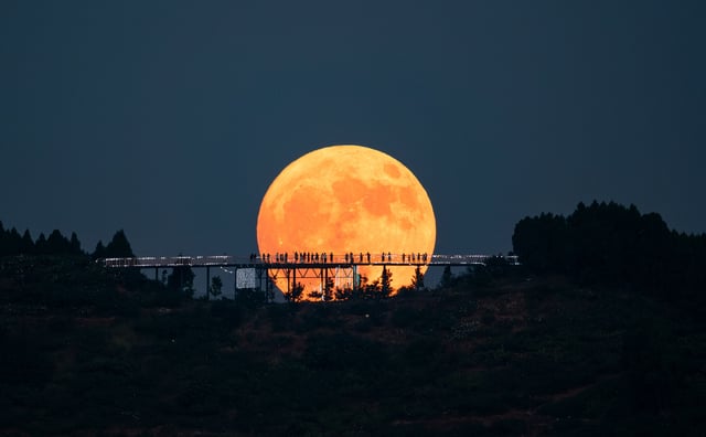 A super blue moon rises behind the Longquan Mountain Observation Deck on Aug. 19, 2024 in Chengdu, China. 