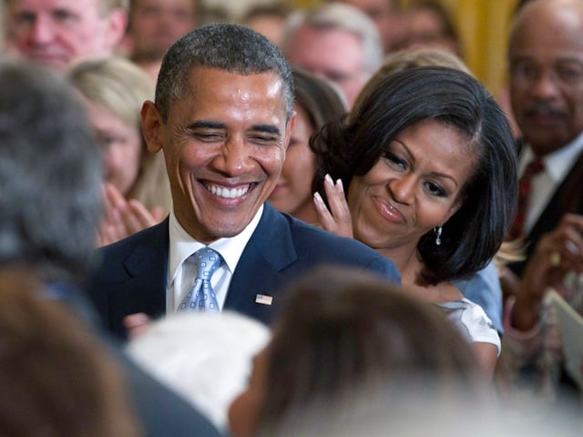FILE - President Barack Obama and first lady Michelle Obama applaud former President George H.W. Bush and former first lady Barbara Bush, not seen, during the portrait unveiling ceremony for former President George W. Bush and former first lady Laura Bush portraits, May 31, 2012, in the East Room of the White House in Washington. Obama's presidential portrait will be unveiled at the White House in a Sept. 7, 2022, ceremony hosted by President Joe Biden. (AP Photo/Carolyn Kaster, File)