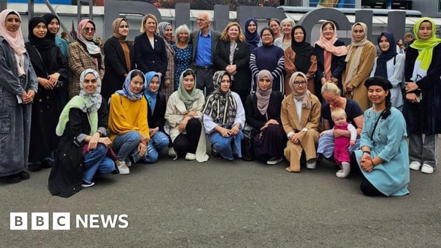 Students with politicians and members of the Linda Norgrove Foundation