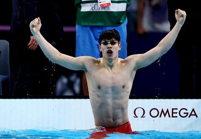 Pan Zhanle celebrates winning 100m freestyle gold at the Paris Games in a world record time. Photo: Reuters