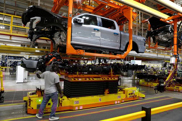 The truck cab is lowered on the frame of Ford Motor Co. battery powered F-150 Lightning trucks.