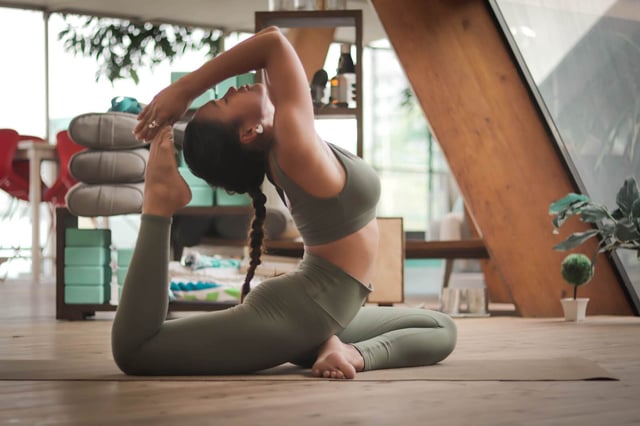 Woman doing yoga in athletic clothing (Photo by Carl Barcelo on Unsplash)