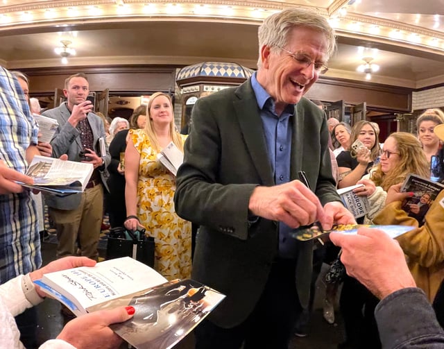 Travel personality Rick Steves autographs books and programs beneath the marquee of AbileneÃ•s Paramount Theatre after his show there Tuesday Feb. 13, 2024.