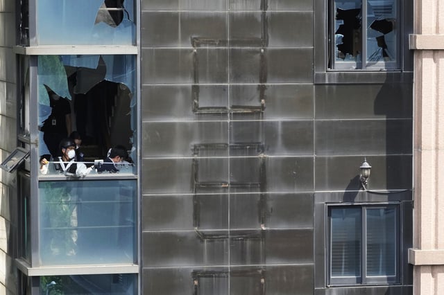 Investigators at the site of a hotel  fire in Bucheon, South Korea, on Aug. 23, 2024. 