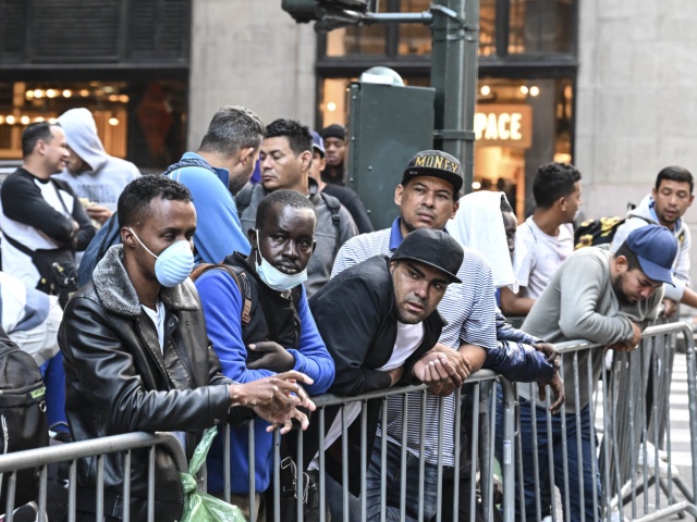 Migrants line up outside Roosevelt Hotel while waiting for placement inside a shelter as asylum seekers camp outside the hotel as the Manhattan relief center is at full capacity in New York, United States on August 02, 2023. Since last spring, New York City has experienced a staggering influx of tens of thousands of asylum seekers. In response to the surge in migration, the city has established more than 160 sites to accommodate and assist these individuals. New York Mayor Eric Adams stated in early June that the city takes on important responsibilities by providing shelter, food, clothing and other essential services to incoming asylum seekers. (Photo by Fatih Aktas/Anadolu Agency via Getty Images).