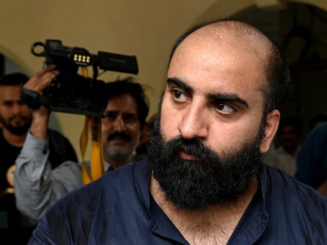 Pakistan's Federal Investigation Agency (FIA) personnel escort Farhan Asif (2R), arrested allegedly over cyber terrorism, to a court in Lahore on August 22, 2024. A Pakistani man appeared in court on August 21, to face charges of cyber terrorism after allegedly spreading disinformation on his clickbait website thought to have fuelled anti-immigration riots in Britain. (Photo by Arif ALI / AFP) (Photo by ARIF ALI/AFP via Getty Images)
