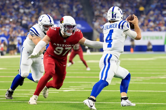 Sam Ehlinger #4 of the Indianapolis Colts avoids a tackle from Cameron Thomas #97 of the Arizona Cardinals during the first half at Lucas Oil Stadium on Aug. 17, 2024 in Indianapolis.