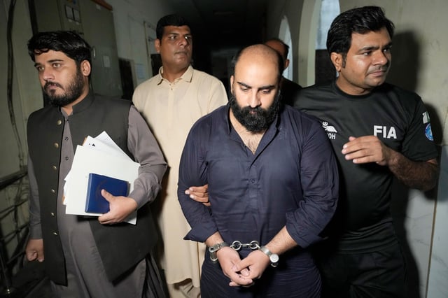 Farhan Asif, second right, is escorted for his court appearance, in Lahore, Pakistan, on Aug. 26, 2024. 