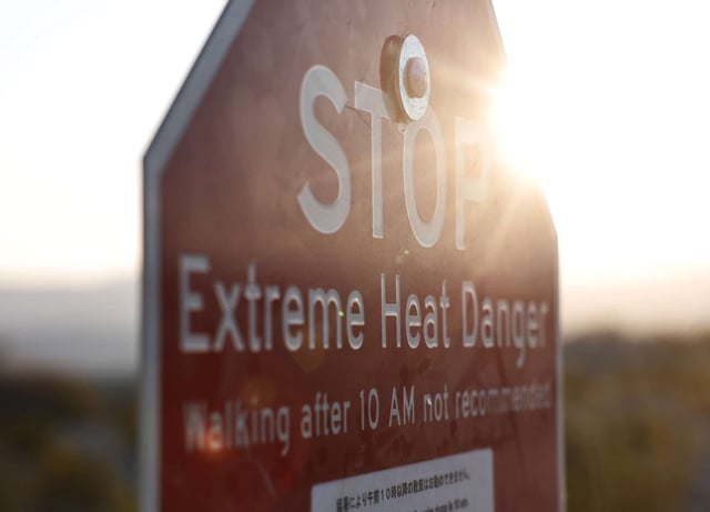 A sign reading Extreme Heat Danger warns visitors during a long-duration heat wave impacting much of the state on July 9, 2024, in Death Valley National Park, California.