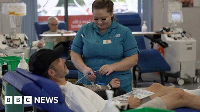 Nurse with man who is donating blood