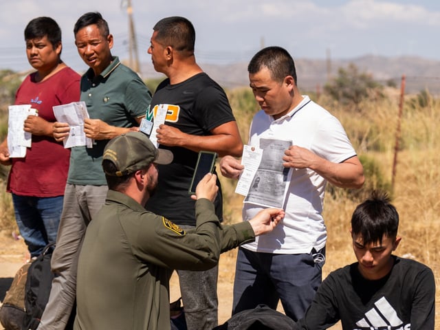 SAN DIEGO, CA - JUNE 13: Migrants are processed by the U.S. Border Patrol near the Jacumba Hot Springs after crossing the US-Mexico border on June 13, 2024 in San Diego, California. (Photo by Qian Weizhong/VCG via Getty Images)