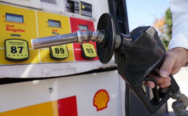 A customer uses a gas pump at a filling station in Falls Church, Virginia, on October 20, 2022.