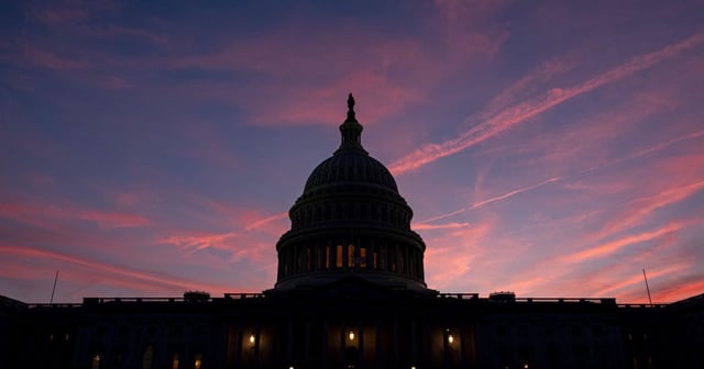 The sunset lights up the sky behind the U.S. Capitol Building as the region prepares for another summer heat wave on Sunday, in Washington, D.C. (Kevin Carter / Getty Images)