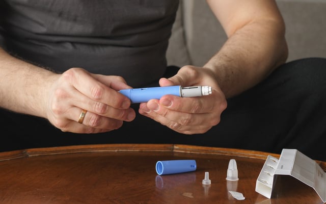 Obese man preparing semaglutide Ozempic injection