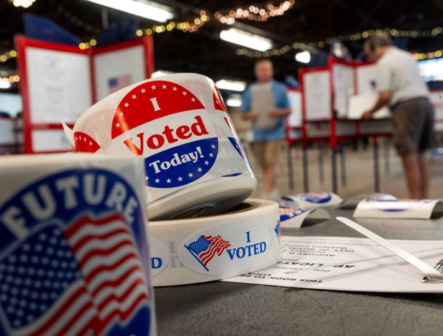 In this August 6 photo, people prepare to cast their ballots in Michigan.