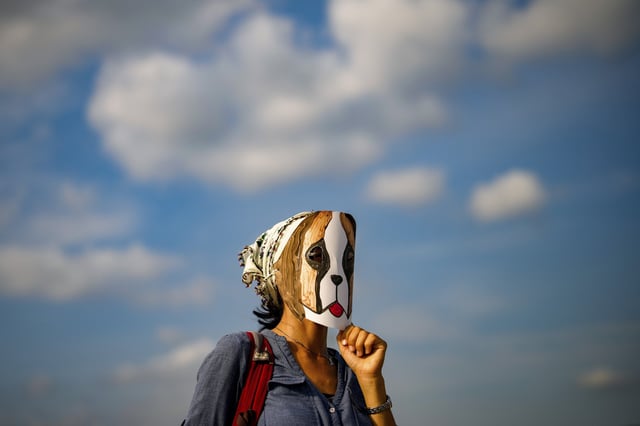 A woman wears a mask during a protest against a bill to remove stray dogs off the country's streets, in Istanbul, Turkey on Sept. 1, 2024.