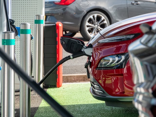 SAINT AUSTELL, UNITED KINGDOM - AUGUST 14: Cars recharge at a charging station for electric vehicles at Cornwall service station near Saint Austell, on August 14, 2024 in Cornwall, England. The government's commitment to reducing future Co2 carbon emissions will mean many more motorists will need to switch from petrol and diesel powered cars to electric (EV) driven ones. However there are also fears that the charging network in the UK is not yet fit to deal with the enormous demand more EVs on the road would place on it.(Photo by Matt Cardy/Getty Images)