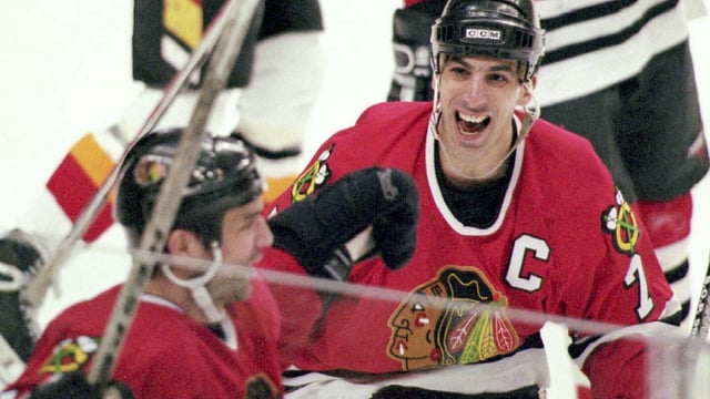 FILE - Chicago Blackhawks captain Chris Chelios, right, congratulates teammate Joe Murphy after Murphy scored the game and series winning goal for the Blackhawks at 10:02 of the third overtime period against the Calgary Flames in Calgary, April 24, 1996. The Blackhawks have decided to retire Hall of Fame defenseman Chris Chelios’ No. 7 jersey. The Blackhawks had Pearl Jam frontman Eddie Vedder deliver the news to his longtime friend during the band’s concert at the United Center on Thursday night, Sept. 7, 2023. (Mike Ridewood/Canadian Press via AP)