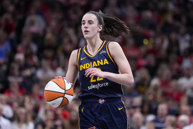 Indiana Fever guard Caitlin Clark (22) plays against the Los Angeles Sparks in the second half of a WNBA basketball game in Indianapolis, Wednesday, Sept. 4, 2024. (AP Photo/Michael Conroy)