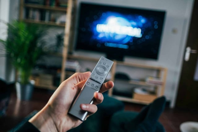 hand holding tv remote