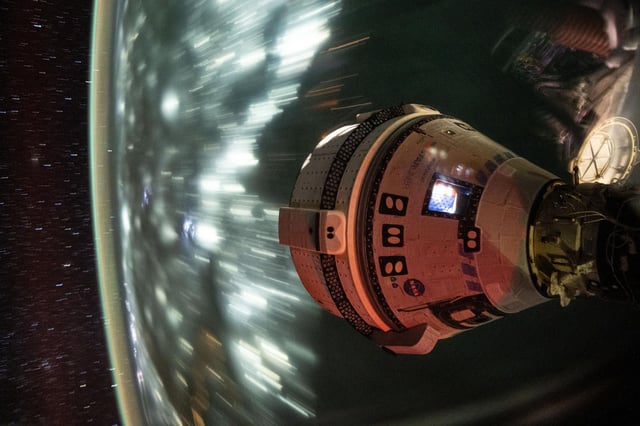 Boeing's Starliner spacecraft that launched NASA's Crew Flight Test astronauts Butch Wilmore and Suni Williams to the International Space Station is pictured docked to the Harmony module's forward port. This long-duration photograph was taken at night on July 3, 2024, from the orbital complex as it soared 256 miles above the Arabian Sea off the coast of Mumbai, India. 
