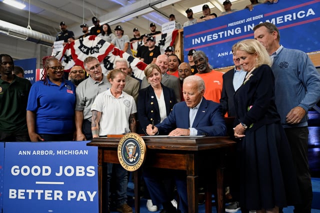 U.S. President Joe Biden signs an executive order during a visit to the United Association Local 190 Training Center in Ann Arbor, Michigan, on September 6, 2024.