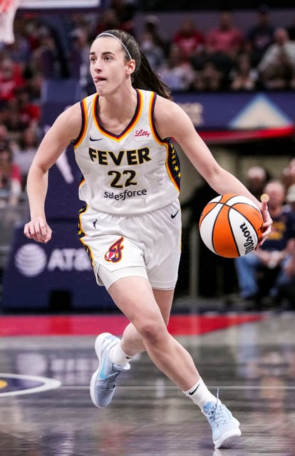 Indiana Fever guard Caitlin Clark (22) dribbles the ball up the court during Friday's game against the Minnesota Lynx at Gainbride Fieldhouse in Indianapolis.