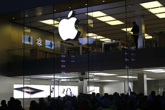 FILE - People wait in front of the Apple store in Munich, Germany, on Sept. 25, 2015. The European Union’s top court has rejected Apple’s final legal challenge against an order from the bloc’s executive commission to repay 13 billion euros in back taxes to Ireland, bringing an end to the long-running dispute