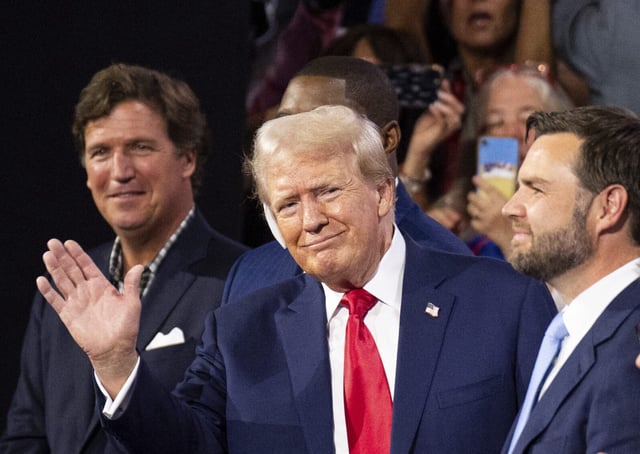 UNITED STATES - JULY 15: Former President Donald Trump waves to the crowd at the Republican National Convention at the Fiserv Forum in Milwaukee, Wisc., on Monday, July 15, 2024. Trump is flanked from left by Tucker Carlson, Rep. Byron Donalds, R-Fla., Vice-President nominee Sen. J.D. Vance, R-Ohio, and Speaker of the House Mike Johnson, R-La. (Bill Clark/CQ Roll Call via AP Images)
