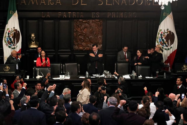Senator Gerardo Fernandez Norona celebrates with senators, after members of Mexico's Senate passed the highly contested proposal on judicial reform presented by the government of President Andres Lopez Obrador, previously approved by the Chamber of Deputies and backed by senators at the commission stage, in Mexico City, Mexico, September 11, 2024. REUTERS/Henry Romero/File Photo