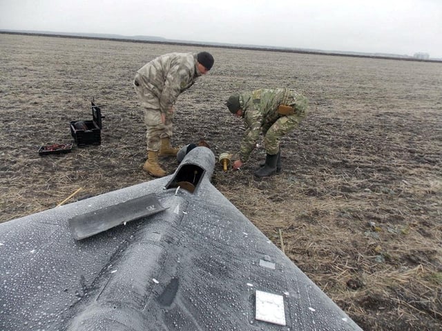 Members of police demining unit remove a warhead from a Russian kamikaze unmanned aerial vehicle landed by a radio electronic warfare during one of latest drone strikes, amid Russia's attack on Ukraine, in an unknown location in Ukraine, in this handout picture released January 26, 2024.  Press service of the National Police of Ukraine/Handout via REUTERS/File Photo