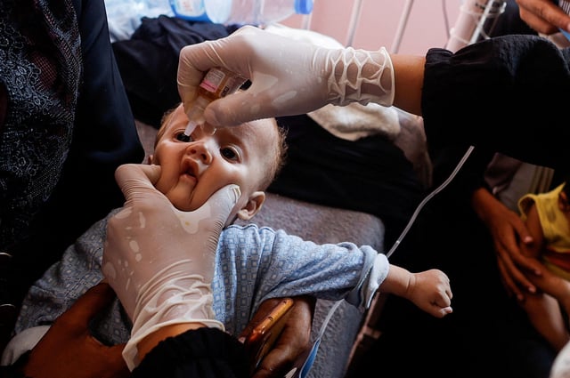 A Palestinian child is vaccinated against polio, amid the Israel-Hamas conflict, at Nasser hospital in Khan Younis in the southern Gaza Strip, August 31, 2024.