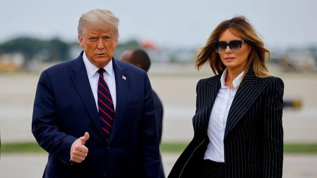 US President Donald Trump walks with first lady Melania Trump at Cleveland Hopkins International Airport in Cleveland, Ohio, on September 29.