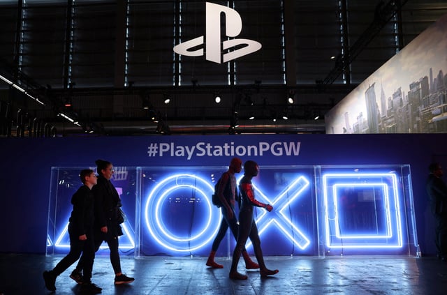 Cosplayers dressed as Spider-Man walk in front of the PlayStation stand at the Paris Games Week (PGW), a trade fair for video games in Paris, France, November 5, 2023. REUTERS/Claudia Greco/File Photo