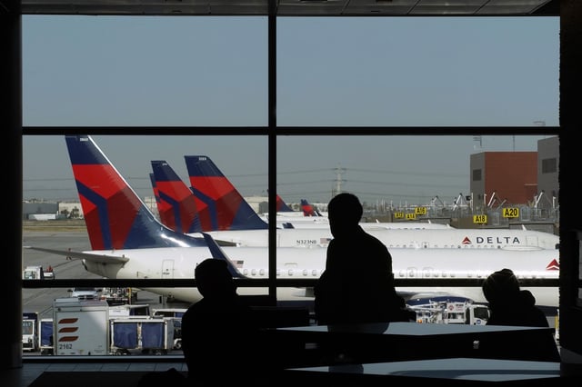 Travelers wait for flights as Delta Air Lines planes sit at gates on opening day of the Salt Lake City International Airport in Salt Lake City, Utah, U.S., on Tuesday, Sept. 15, 2020.