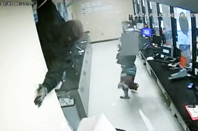 A robber falls through the ceiling of a check cashing business in southwest Atlanta on Sept. 3.