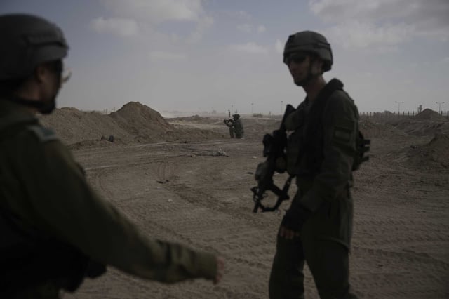 Israeli soldiers take up positions next to the Philadelphi Corridor along the border with Egypt, in the Gaza Strip on Friday, Sept. 13, 2024.