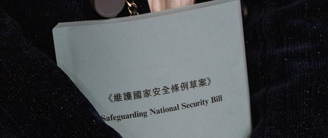Members of the Legislative Council are holding a booklet of the Safeguarding National Security Bill in Hong Kong on March 8, 2024. The Legislative Council is currently holding the First Reading and Second Reading of the Safeguarding National Security Bill, also known as the Article 23 legislation.
