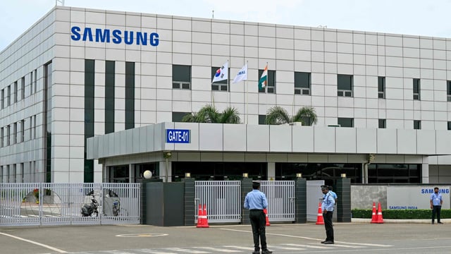 Security personnel stand guard at Samsung India's plant in Sriperumbudur, near Chennai on September 11, 2024, as workers stage a protest to demand higher wages and recognition of their union.
