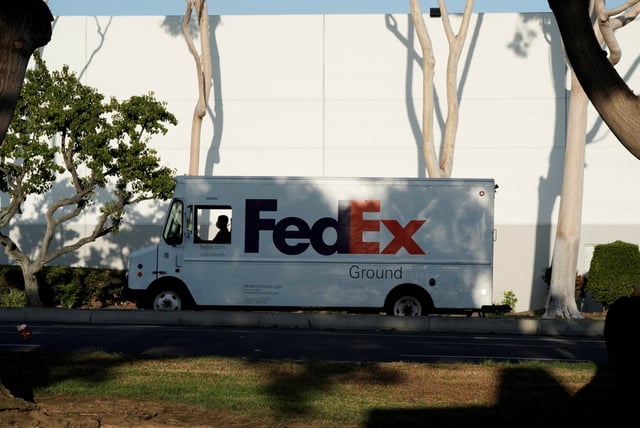 A FedEx last-mile delivery van is seen near a FedEx Ground distribution center in Carson, California, U.S., September 16, 2022.  REUTERS/Bing Guan/File photo