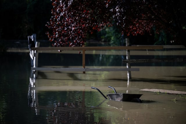 A wheelbarrow is partially submerged in water following flooding by the Danube River in Budapest, Hungary, September 20, 2024. REUTERS/Marton Monus